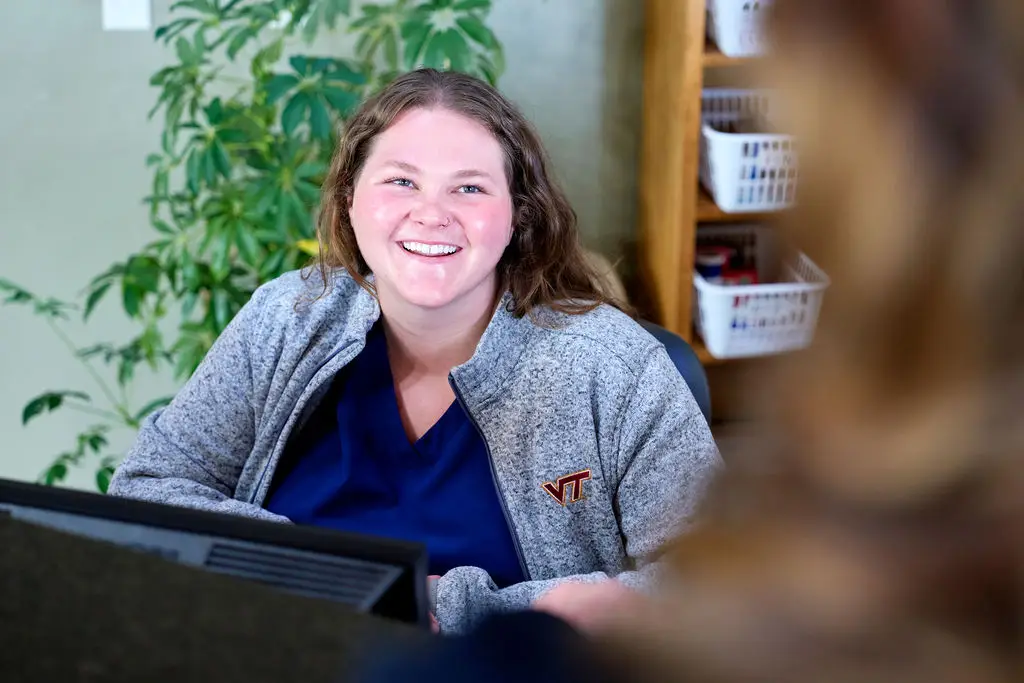 Friendly front desk staff member assisting a client at Ridgewood Animal Hospital in Forest, Virginia